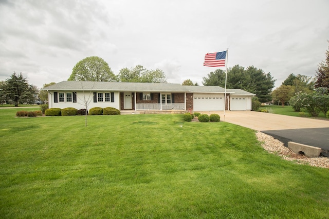 ranch-style home featuring a garage, covered porch, concrete driveway, and a front lawn