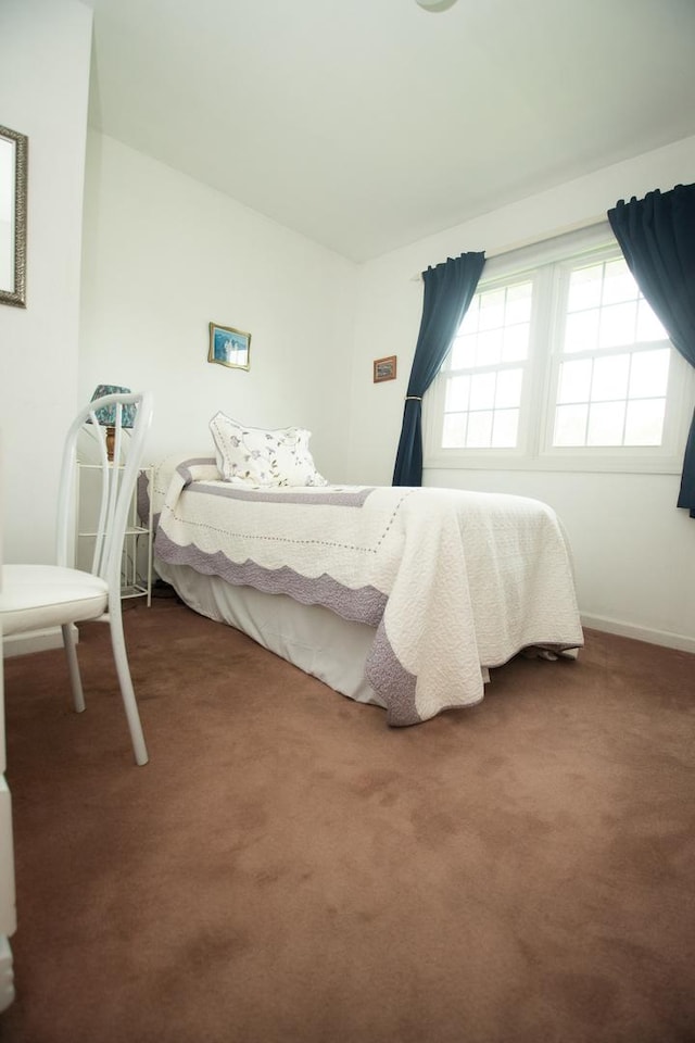 bedroom featuring carpet flooring and baseboards