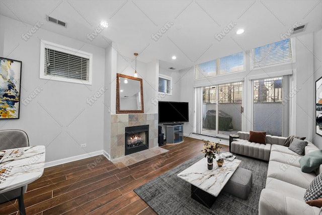 2515 W Harrison St Unit 1, Chicago, IL 60612 - living room featuring visible vents, wood finished floors, baseboards, recessed lighting, and a tiled fireplace