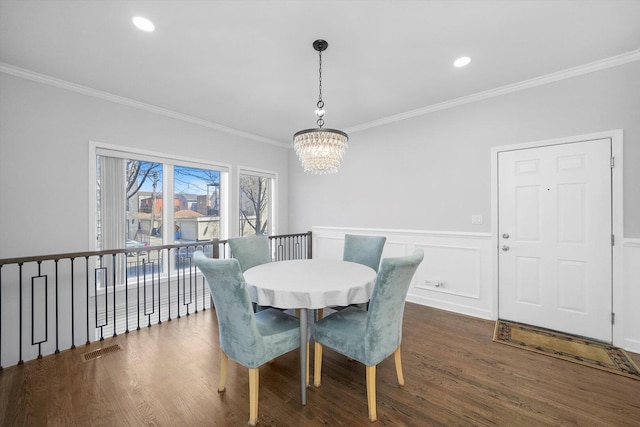 2515 W Harrison St Unit 1, Chicago, IL 60612 - dining space featuring visible vents, ornamental molding, dark wood-style flooring, wainscoting, and a notable chandelier
