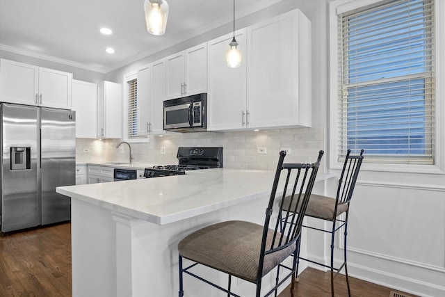2515 W Harrison St Unit 1, Chicago, IL 60612 - kitchen with crown molding, decorative backsplash, white cabinetry, light stone counters, and appliances with stainless steel finishes