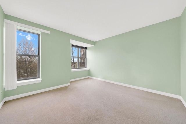 carpeted spare room with baseboards