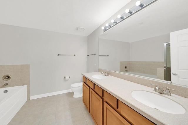 bathroom with baseboards, tile patterned flooring, a sink, and a garden tub