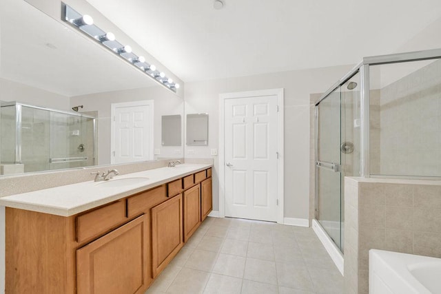 full bathroom featuring tile patterned flooring, a sink, a stall shower, and double vanity