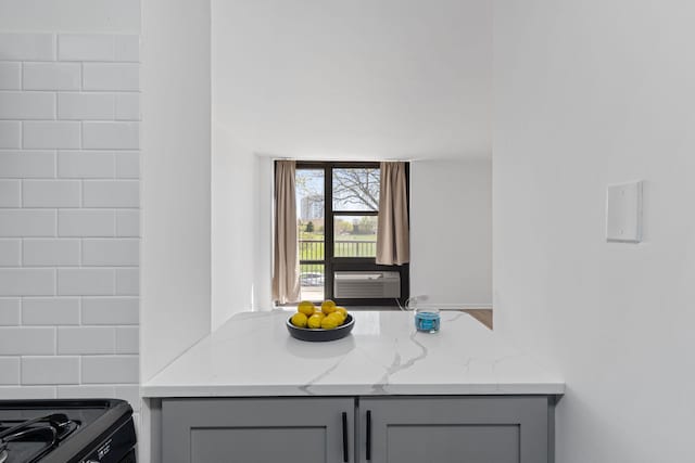 interior space featuring gray cabinets, cooling unit, and light stone countertops