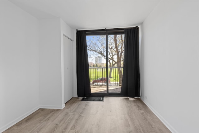 entryway featuring baseboards and light wood finished floors
