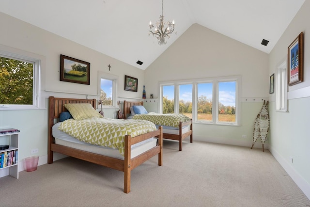 bedroom featuring an inviting chandelier, high vaulted ceiling, and light carpet