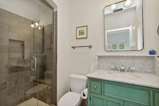 bathroom with toilet, visible vents, a shower stall, and vanity