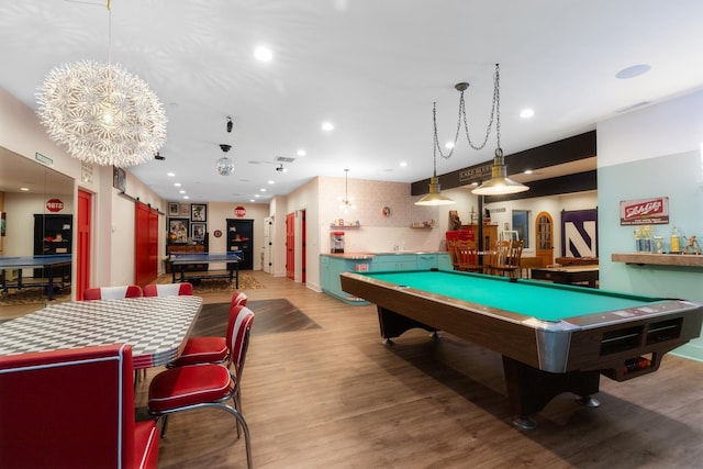 game room with wood finished floors, recessed lighting, pool table, and a barn door