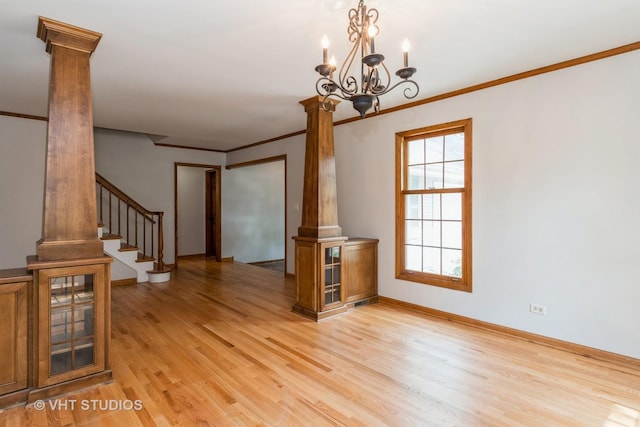 6S475 Sussex Rd, Naperville, IL 60540 - empty room with ornate columns, light wood-style floors, crown molding, a chandelier, and stairway