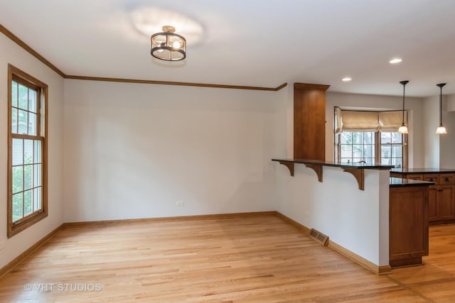 6S475 Sussex Rd, Naperville, IL 60540 - unfurnished dining area with light wood-type flooring, healthy amount of natural light, crown molding, and recessed lighting