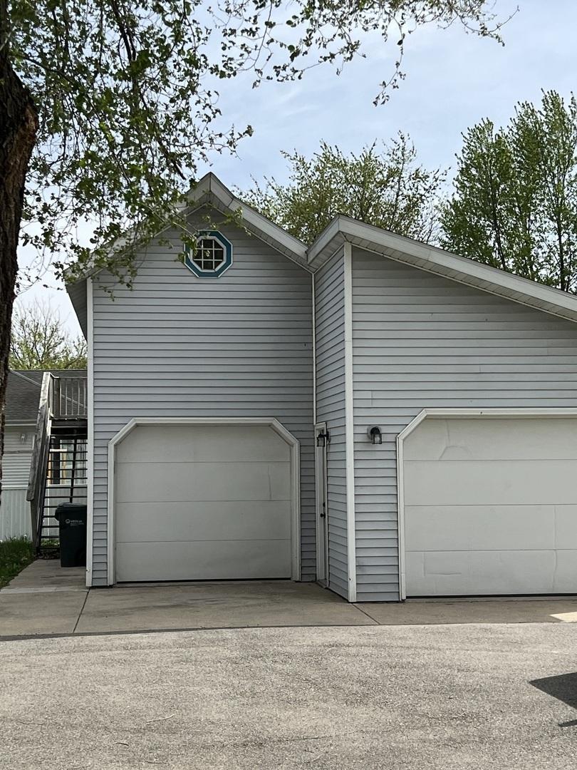 exterior space with a garage and stairway