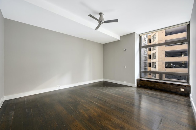 spare room featuring baseboards, a ceiling fan, and wood finished floors