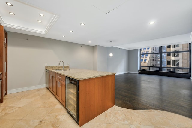 kitchen with light stone counters, a sink, recessed lighting, a peninsula, and wine cooler