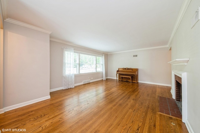 1008 N Vail Ave, Arlington Heights, IL 60004 - unfurnished living room with light wood-style flooring, crown molding, a fireplace with flush hearth, and baseboards
