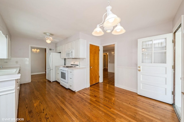 1008 N Vail Ave, Arlington Heights, IL 60004 - kitchen with white appliances, wood finished floors, a ceiling fan, light countertops, and a wainscoted wall
