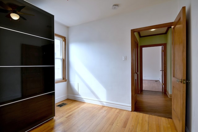 7840 W Cressett Dr, Elmwood Park, IL 60707 - unfurnished bedroom with light wood-style flooring and baseboards