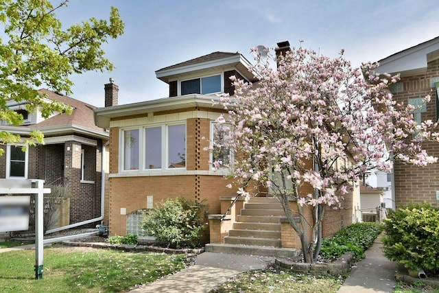7840 W Cressett Dr, Elmwood Park, IL 60707 - view of front of house with a chimney and brick siding