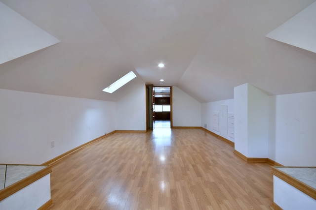 7840 W Cressett Dr, Elmwood Park, IL 60707 - bonus room featuring a skylight, light wood-style flooring, vaulted ceiling, and baseboards