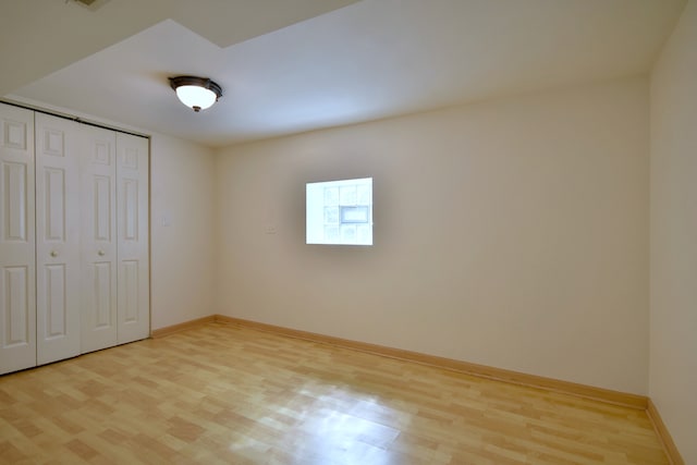 7840 W Cressett Dr, Elmwood Park, IL 60707 - unfurnished bedroom with light wood-style flooring, baseboards, and a closet
