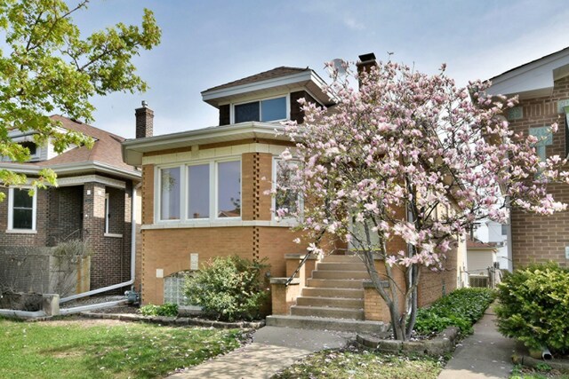 7840 W Cressett Dr, Elmwood Park, IL 60707 - view of front of home featuring a chimney and brick siding