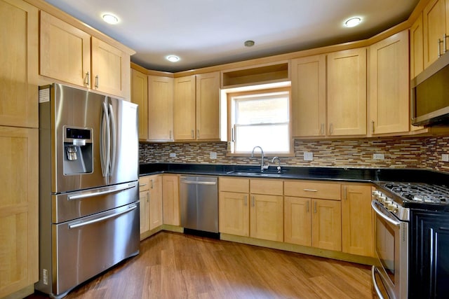 7840 W Cressett Dr, Elmwood Park, IL 60707 - kitchen featuring appliances with stainless steel finishes, a sink, light brown cabinetry, dark countertops, and recessed lighting