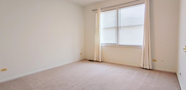 empty room with baseboards, carpet, and visible vents