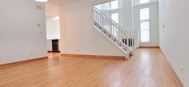 stairs with baseboards and wood finished floors
