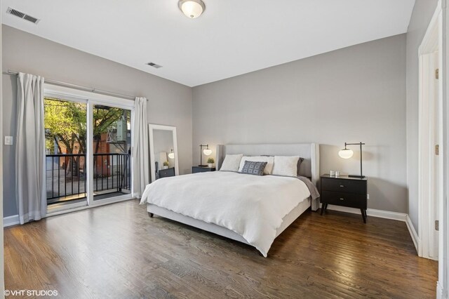 bedroom featuring baseboards, dark wood finished floors, access to exterior, and visible vents