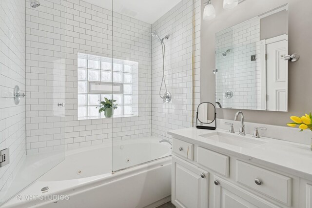 full bath featuring vanity and a combined bath / shower with jetted tub