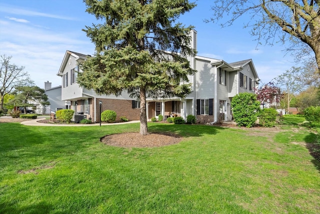 387 Coventrey Ct Unit 0, Clarendon Hills, IL 60514 - view of front facade featuring a chimney, brick siding, cooling unit, and a front lawn