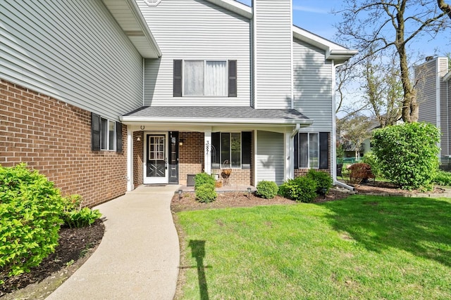 387 Coventrey Ct Unit 0, Clarendon Hills, IL 60514 - doorway to property with a lawn, brick siding, a chimney, and a porch