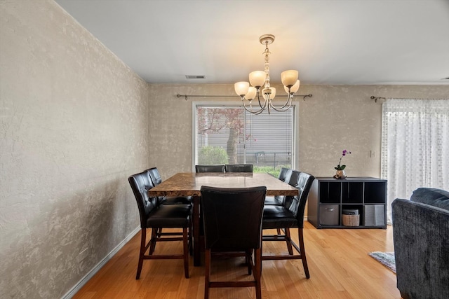 387 Coventrey Ct Unit 0, Clarendon Hills, IL 60514 - dining space with a chandelier, light wood-type flooring, and a textured wall