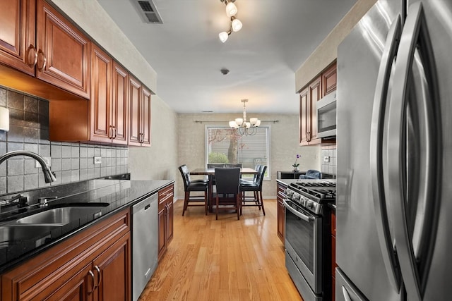387 Coventrey Ct Unit 0, Clarendon Hills, IL 60514 - kitchen featuring stainless steel appliances, a sink, tasteful backsplash, light wood-type flooring, and a chandelier