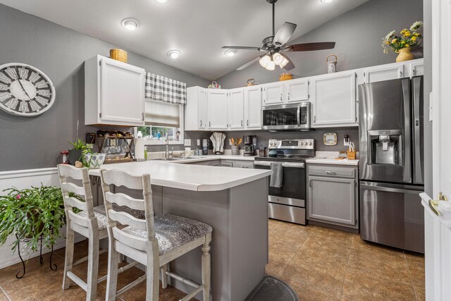 611 Northgate Dr, Saint Joseph, IL 61873 - kitchen with appliances with stainless steel finishes, a peninsula, lofted ceiling, a sink, and light countertops