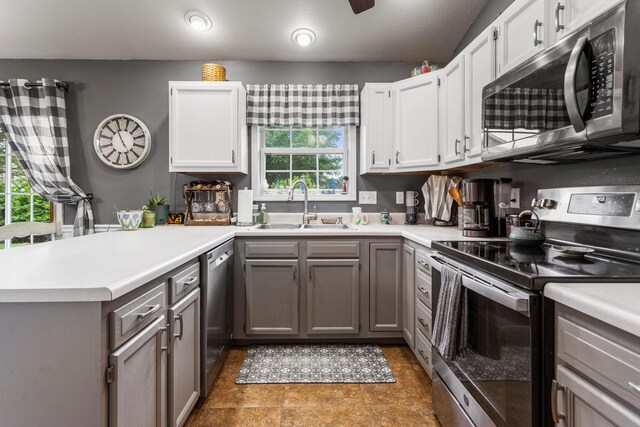 611 Northgate Dr, Saint Joseph, IL 61873 - kitchen featuring appliances with stainless steel finishes, a sink, a peninsula, and light countertops