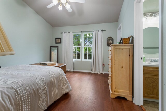 611 Northgate Dr, Saint Joseph, IL 61873 - bedroom with vaulted ceiling, dark wood-style floors, baseboards, ceiling fan, and a sink
