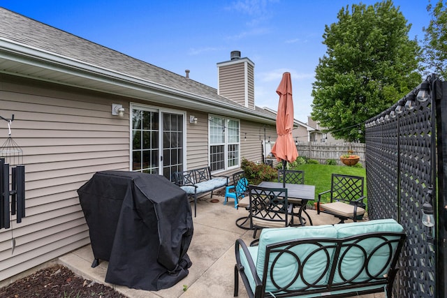 611 Northgate Dr, Saint Joseph, IL 61873 - fenced backyard with a patio, outdoor dining area, and a grill