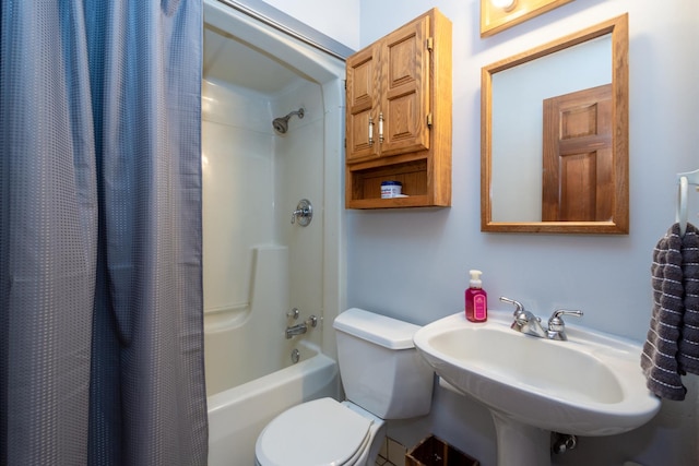 full bath featuring toilet, a sink, and shower / bath combination with curtain