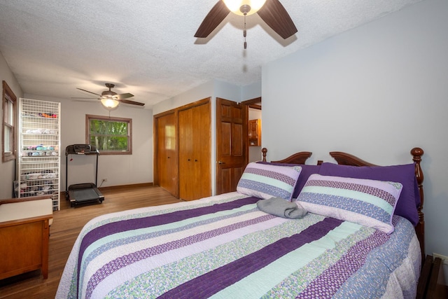 bedroom with wood finished floors, a closet, a textured ceiling, and ceiling fan