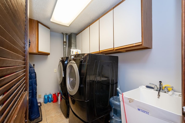clothes washing area with cabinet space, independent washer and dryer, and light tile patterned floors