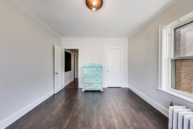 918 Michigan Ave Unit 3, Evanston, IL 60202 - unfurnished room featuring radiator, ornamental molding, and dark wood-style flooring