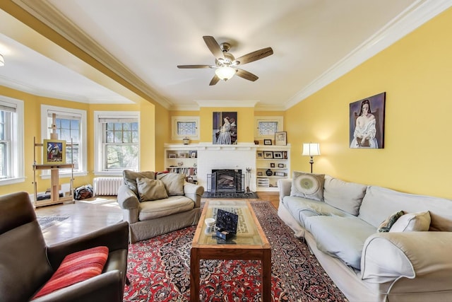 918 Michigan Ave Unit 3, Evanston, IL 60202 - living room featuring crown molding, radiator, a ceiling fan, a brick fireplace, and wood finished floors