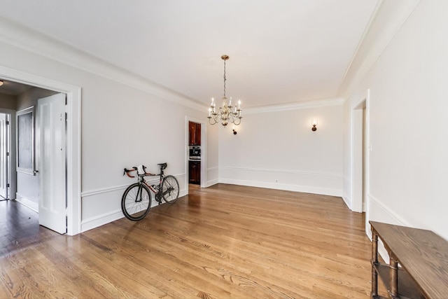 918 Michigan Ave Unit 3, Evanston, IL 60202 - spare room featuring a chandelier, light wood-style floors, and crown molding
