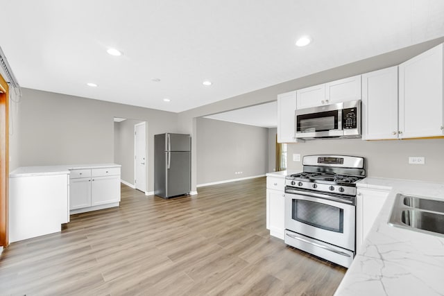 1595 Highland Blvd, Hoffman Estates, IL 60169 - kitchen with white cabinetry, appliances with stainless steel finishes, a sink, and light wood finished floors