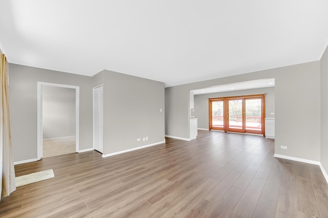 1595 Highland Blvd, Hoffman Estates, IL 60169 - unfurnished living room featuring baseboards and wood finished floors