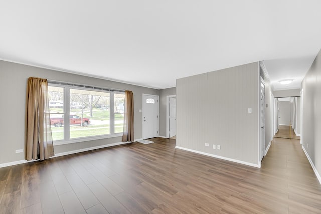 1595 Highland Blvd, Hoffman Estates, IL 60169 - unfurnished living room with crown molding, baseboards, visible vents, and wood finished floors