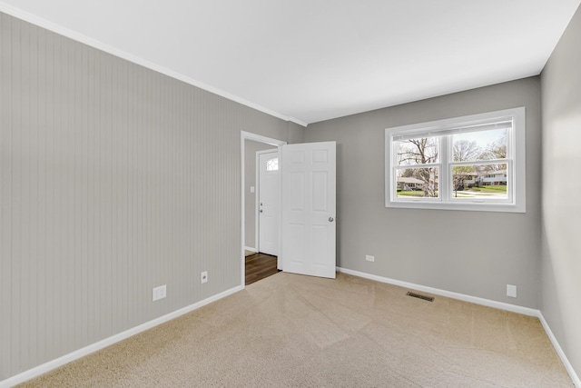 1595 Highland Blvd, Hoffman Estates, IL 60169 - carpeted spare room with baseboards, ornamental molding, and visible vents