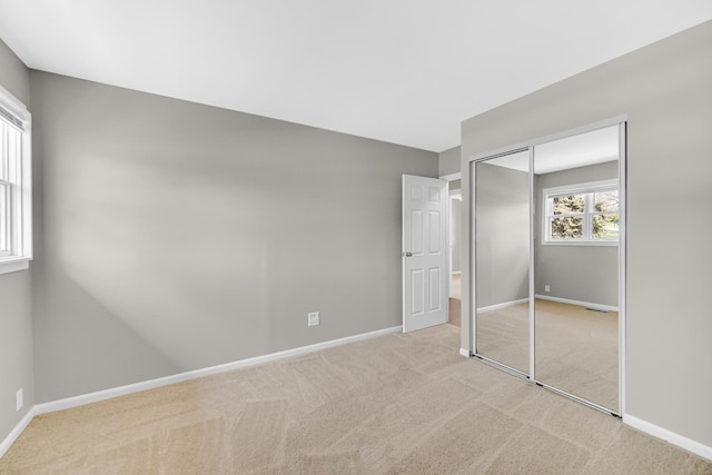 1595 Highland Blvd, Hoffman Estates, IL 60169 - unfurnished bedroom with baseboards, light colored carpet, and a closet