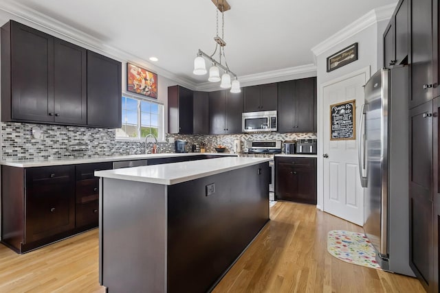 1000 Salvia Ln, Joliet, IL 60431 - kitchen with crown molding, stainless steel appliances, light countertops, and light wood-type flooring
